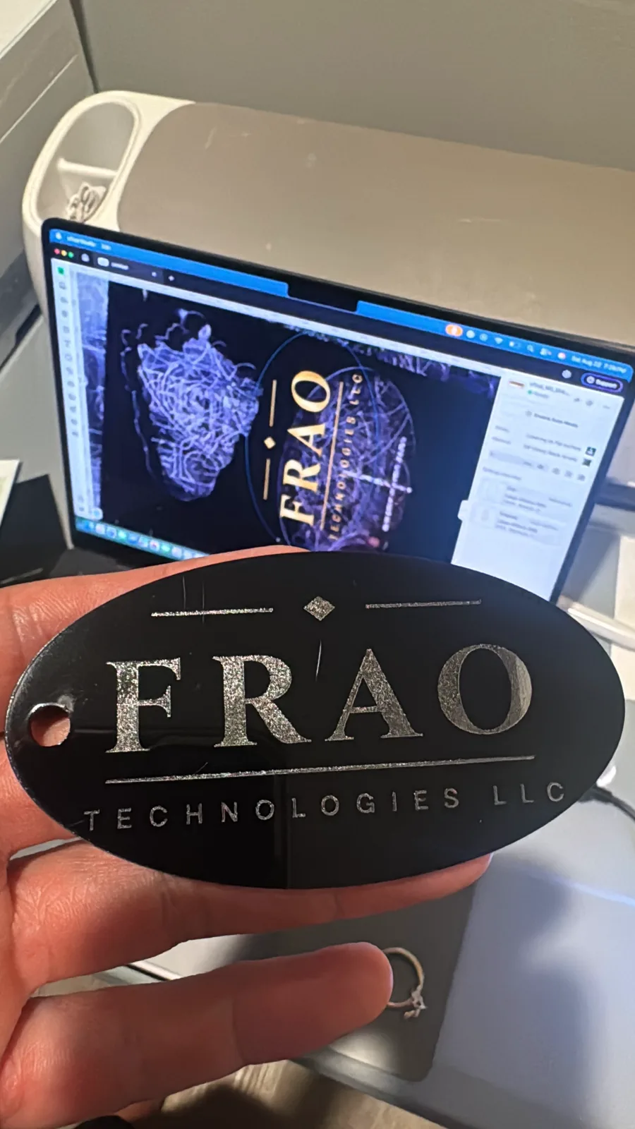Laser-engraved Frao Technologies badge